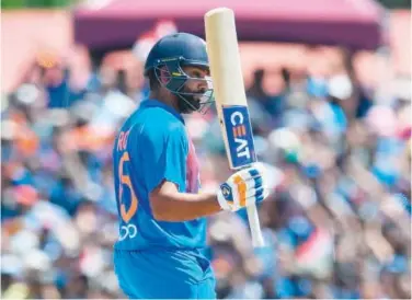  ?? Agence France-presse ?? ↑ India’s Rohit Sharma celebrates after scoring a half-century against West Indies during their second T20 match on Sunday.