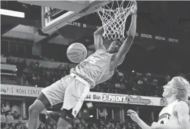  ?? JOVANNY HERNANDEZ / MILWAUKEE JOURNAL SENTINEL ?? St. Thomas More’s Sekou Konneh dunks against Prescott during a WIAA Division 3 boys basketball state semifinal Thursday at the Kohl Center in Madison.