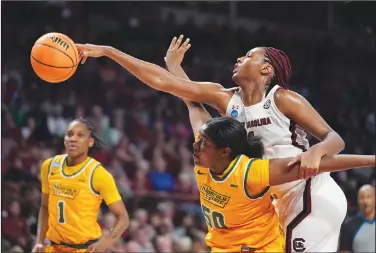  ?? Associated Press ?? Reaching over: South Carolina forward Aliyah Boston (4) reaches over Norfolk State forward Kierra Wheeler (50) in the mrst half of a mrst round colleHe CasketCall HaNe in the NCAA 5ournaNent 'riday in ColuNCia S C