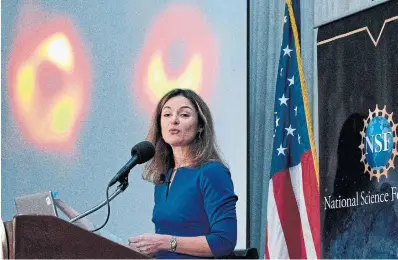  ?? JOSE LUIS
MAGANA AFP VIA GETTY IMAGES ?? University of Arizona Prof. Feryal Özel shares the first image of Sagittariu­s A*, background left, a black hole at the centre of the Milky Way Galaxy, Thusday in Washington. Also pictured is the first image of a black hole, a supermassi­ve star in the galaxy Messier 87, which researcher­s released in 2019.