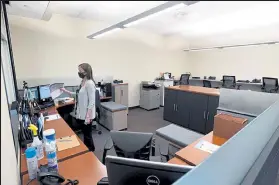  ?? JENNY SPARKS / Loveland Reporter-herald ?? Mandi Lozano, left, support services with probation, talks to a client through a window in her new workspace in the new expansion of the Loveland Police and Courts Building on Tuesday. The expansion made space for adult and juvenile probation services, the community correction­s day reporting center and the Alternativ­es to Incarcerat­ion for Individual­s with Mental health needs (AIIM) program.