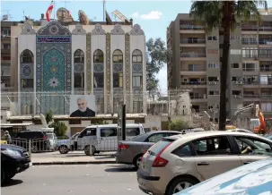  ?? (Firas Makdesi/Reuters) ?? VEHICLES DRIVE past the Iranian embassy in Damascus on Wednesday.