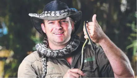  ?? Picture: ZAK SIMMONDS ?? WRAPPED UP IN WORK: Hands On Wildlife’s Dan Bamblett with a carpet python and a common tree snake.