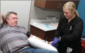  ?? The Sentinel-Record/Richard Rasmussen ?? URGENT NEED: Apheresis technician Alexandra Mason, right, works with donor Greg Robbins at the Arkansas Blood Institute on Friday. ABI is asking donors of all blood types to give as soon as possible due to a winter storm that affected Oklahoma this week.