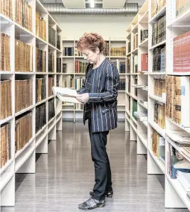  ?? MARTA GIACCONE The New York Times ?? Krista Aru, the director of the Tartu University library, inspects a first edition of Gogol’s “Dead Souls,” on April 29 in in Tartu, Estonia, where eight books disappeare­d from the library. Police are looking into who has been stealing rare Russian books from European libraries – and why.