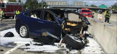  ?? KTVU VIA AP ?? In this March 23 file photo provided by KTVU, emergency personnel work a the scene where a Tesla electric SUV crashed into a barrier on U.S. Highway 101 in Mountain View.