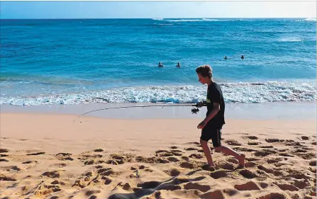  ?? DANIEL BEEKMAN THE SEATTLE TIMES/TNS ?? Warm waves and hot sand make Kiahuna Beach on Kauai’s South Shore a favourite for casual swimming.