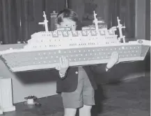  ??  ?? 0 Ian Pemberton, 7, with a Lego model liner in 1962 - the classic building bricks debuted on this day in 1958