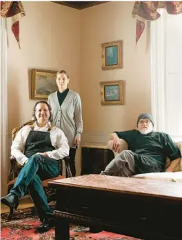  ?? TRISTAN SPINSKI/THE NEW YORK TIMES ?? Arnaud and Allison Lessard, and Kip Dixon, co-owners of the Homeport Inn and Tavern, pose Jan. 20 in the inn’s living room in Searsport, Maine.