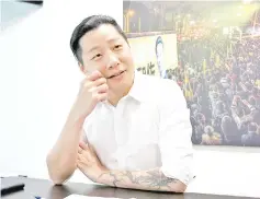  ??  ?? Freddy Lim is seen in his office in Taipei in front of an photograph of his band, Chthonic, in concert. — Washington Post photo by Hsu Yu Shan