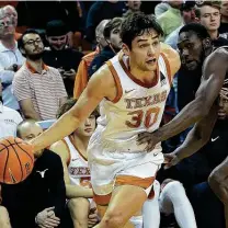  ?? Chris Covatta / Getty Images ?? Brock Cunningham, left, didn’t score in the second half, but his defense played a key role in Texas’ victory.