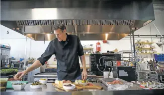  ?? PHOTOS BY GABRIELA CAMPOS/THE NEW MEXICAN ?? Adobo Catering’s executive chef, Brian Rood, puts the final touches on charcuteri­e boards in its kitchen at Second Street Studios.