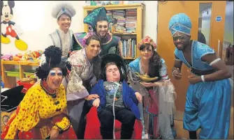  ??  ?? ■ Pictured are the cast of Aladdin from Leicester’s De Montfort Hall with Cody at Rainbows Hospice in Loughborou­gh.