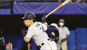  ?? Koji Watanabe / TBS ?? Outfielder Masataka Yoshida (34) of Team Japan hits an infield single in the fourth inning against Team United States during the gold medal game of the 2020 Olympic Games in Tokyo.