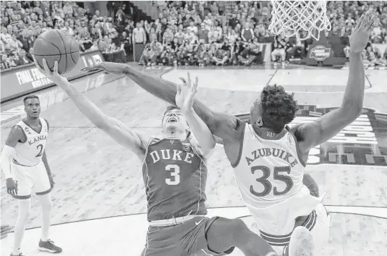  ?? Nati Harnik / Associated Press ?? Duke’s Grayson Allen (3) is fouled on his way to the basket by Kansas’ Udoka Azubuike during the second half of Sunday’s regional final at Omaha, Neb.