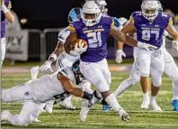  ?? James Franco / Special to the Times Union ?? UAlbany running back Karl Mofor picks up yardage in front of Rhode Island defender Evan Stewart during the Great Danes home opener on Saturday.