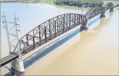  ?? JEFF ROBERSON — THE ASSOCIATED PRESS ?? The Merchants Bridge crosses the Mississipp­i River in St. Louis. The 127-yearold railroad bridge is in danger of being shut down if it is not replaced soon, but officials are struggling with how to pay for a planned repair and the 12,500 tons of steel...