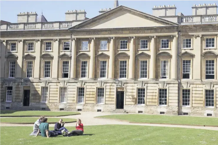  ?? FOTO: AFP ?? Estudiante­s sentados afuera de una de las dependenci­as de la Universida­d de Oxford.