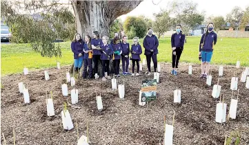  ??  ?? Viewing their completed planting work are (from left) Samantha Smith, Pippa Bryant, Indie McDonald, Paige Dougheney, Chelsie Smith, Lilli Ashman, Hannah West, Zoe Dougheney, Gemma Vassallo, Sascha Van de Burgt and Libby Haynes.