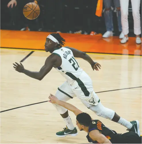  ?? ROSS D. FRANKLIN / THE ASSOCIATED PRESS ?? Milwaukee Bucks guard Jrue Holiday has been doing it at both ends of the court in the NBA finals against Phoenix.