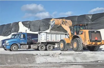  ?? MICHA EL SEARS / MILWAUKEE JOURNAL SENTINEL ?? Trucks load up with salt Friday on Jones Island. City crews are applying a salt brine solution to roadways. Photos at jsonline.com/news.