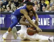  ?? MATT SLOCUM — THE ASSOCIATED PRESS ?? Villanova’s Darryl Reynolds, right, tries to hang onto a loose ball against Seton Hall’s Desi Rodriguez during the second half Monday. Villanova won 76-46.