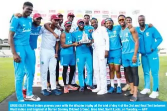  ??  ?? GROS ISLET: West Indies players pose with the Wisden trophy at the end of day 4 of the 3rd and final Test between West Indies and England at Darren Sammy Cricket Ground, Gros Islet, Saint Lucia, on Tuesday.— AFP