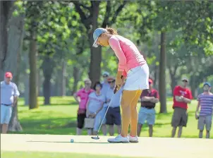  ??  ?? / FOR THE JOURNAL SENTINEL Annie Park sinks a birdie putt on the back nine Sunday as she starts her battle back to first place during the final round of the PHC Classic at Brown Deer Park Golf Course.