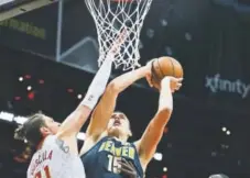  ?? John Bazemore, The Associated Press ?? Nuggets center Nikola Jokic, shooting over the defense of Mike Muscala of the Atlanta Hawks, is playing with great confidence.