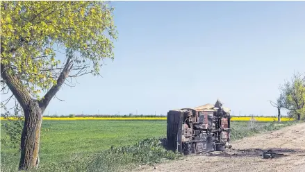  ?? ?? PICKING THEM OFF: A charred vehicle lies on a dirt road linking Ukrainian front positions in the Kherson region of southern Ukraine.