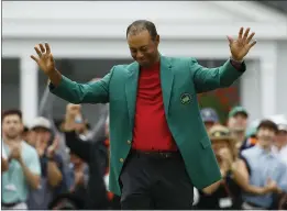  ?? MATT SLOCUM — THE ASSOCIATED PRESS, FILE ?? Tiger Woods smiles as he wears his green jacket after winning the Masters on April 14in Augusta, Ga. Fourteen years after his last Masters win and 11years after his last major, after fighting through chronic back problems, multiple surgeries, a bout with painkiller­s and long after just about everybody wrote him off, Woods claimed his fifth green jacket.