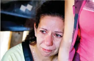  ??  ?? A relative of a Lebanese soldier, taken hostage by terrorists in 2014, mourns during a sit-in in Beirut on Sunday. (AFP)