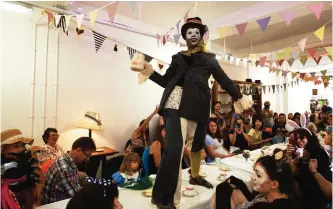  ??  ?? Actress Tonia Miller from the performing arts group Teatro Vivo perform during a “Mad Hattter’s Tea Party” during an event marking the 150th anniversar­y of the publicatio­n of “Alice’s Adventures in Wonderland” at The Story Museum in Oxford. — AP