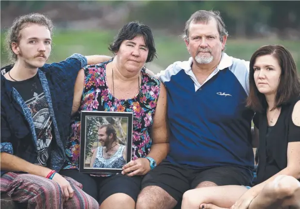  ?? Picture: ANNA ROGERS ?? DESPERATE PLEA: Janice and Graham Bradley (centre) and siblings Michael and Johanna hold a photo of son and brother Scott Bradley, who was killed in a hit-and-run near Mossman last month. The family is urging the driver to come forward.