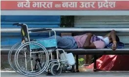  ?? — G.N. JHA ?? A Divyang takes a nap at a deserted Bus stop during the nationwide lockdown on Saturday.