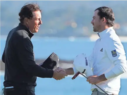  ?? KYLE TERADA-USA TODAY SPORTS ?? Phil Mickelson (left) congratula­tes Nick Taylor (right) after Taylor won during the final round of the AT&T Pebble Beach Pro-am golf tournament at Pebble Beach Golf Links.