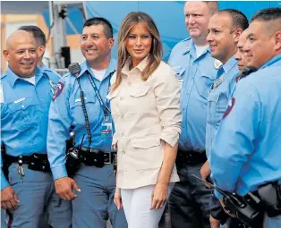  ??  ?? Mrs Trump meets police in McAllen, Texas, yesterday, before visiting the centre