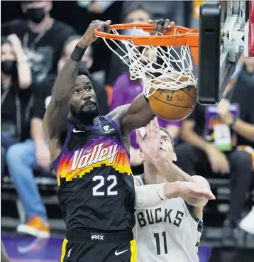  ?? ROSS D. FRANKLIN — THE ASSOCIATED PRESS ?? Phoenix Suns center Deandre Ayton dunks against Milwaukee Bucks center Brook Lopez in the second half of Game 1.