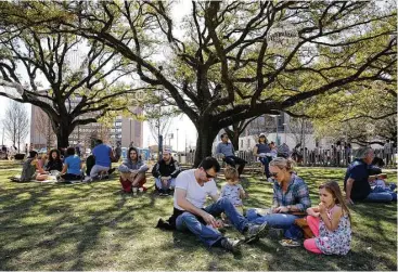  ?? Yi-Chin Lee / Houston Chronicle ?? Members of the Rogers family enjoy their picnic at the grand reopening of Levy Park on Saturday. It was the Houston family’s first visit to the park, whose design preserved 30 live oak trees.