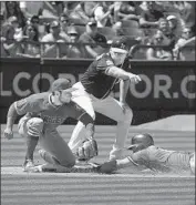  ?? Jeff Chiu Associated Press ?? CHAD PINDER gets a triple ahead of a throw to David Fletcher as coach Matt Williams looks on.