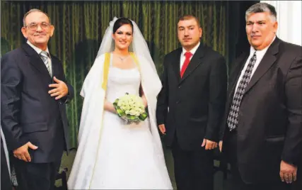  ?? ISSA ABU OTHMAN/REUTERS ?? Askraf Akhras and his bride Nadia Alami pose with their fathers during their wedding reception at Amman’s Radisson SAS hotel on Wednesday, before an explosion ripped through the hotel, killing both fathers. The groom’s mother was clinging to life last...