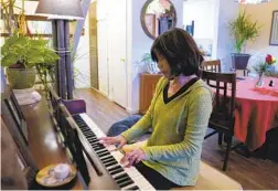  ?? NELVIN C. CEPEDA U-T ?? Carmen Kcomt plays the piano, which she used to teach on the sly to support her family when she first fled to the U.S. from Peru in the early 2000s.