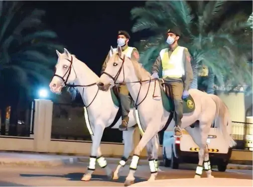  ?? ?? Dubai Mounted Police play a s\ignificant role in educating the public about movement restrictio­ns and safety measures.