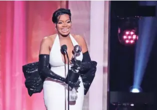  ?? AP PHOTOS/CHRIS PIZZELLO ?? Fantasia Barrino, a cast member in “The Color Purple,” accepts the award for Outstandin­g Actress in a Motion Picture on Saturday during the NAACP Image Awards at the Shrine Auditorium in Los Angeles.