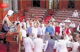  ?? PTI ?? MPs of Opposition parties storm into the well of the Rajya Sabha to protest against the government's decision to phase out LPG subsidy on Tuesday. Demanding a rollback, they later walked out on the issue. A united opposition also stalled the prenoon...