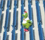  ?? CHRIS SZAGOLA — THE ASSOCIATED PRESS ?? The Phillie Phanatic looks on from the empty stands during the seventh inning of a baseball game against the Miami Marlins, Sunday.