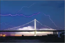  ?? NOAH BERGER — THE ASSOCIATED PRESS FILE ?? On Aug. 16, lightning forks over the San Francisco-Oakland Bay Bridge as a storm passes over Oakland. Numerous lightning strikes sparked brush fires throughout the region.