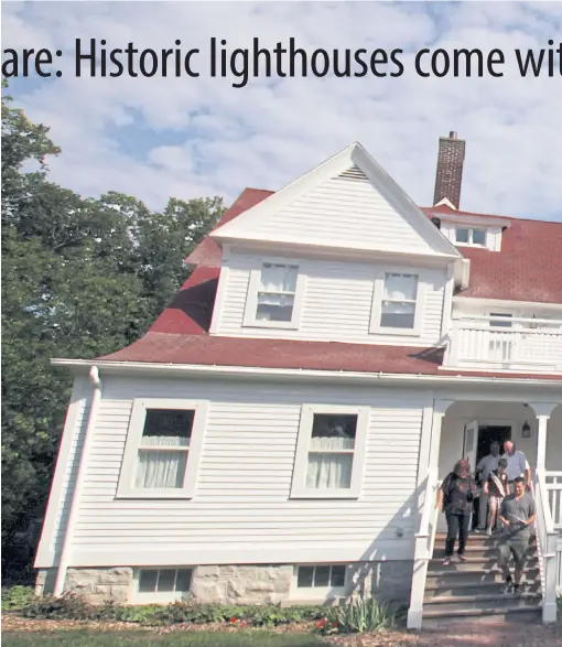  ??  ?? A family walks out of the North Point Lighthouse in Milwaukee after a tour.