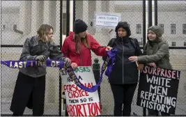  ?? PHOTOS BY AMANDA ANDRADE-RHOADES — THE ASSOCIATED PRESS ?? Abortion-rights protesters pass along an ongoing art project called “Line up for Roe” by Dr. Katherine Westaway outside of the U.S. Supreme Court on Saturday in Washington.