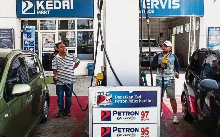  ??  ?? Rising fortune: Customers refuelling at a Petron petrol station in Kota Kinabalu. Shares of Petron have surged almost 200% so far this year. — Bloomberg